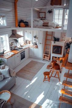 an aerial view of a kitchen and living room in a tiny house with white walls