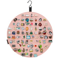 a pink circle with many different pins and magnets on it