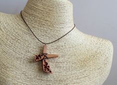 This handmade carved wooden cross necklace was made from pear wood, polished and finished with fine tung oil. This hippie style wood cross can be perfect gift for man or gift for woman. CROSS GALLERY : https://www.etsy.com/shop/NikibarsNatureArt?section_id=16787849&ref=shopsection_leftnav_5 cross height - 1 7/8 inches (47 mm) The length of the cord is about 30 inches (77 cm), but it can be regulated by the movable knot. Materials utilised: pear wood, waxed cord Production method 100% hand ma Handmade Brown Crucifix Necklace, Brown Wooden Beads Cross Necklace, Handmade Brown Cross Pendant Necklace, Handmade Brown Cross Necklace, Brown Cross Necklace With Wooden Beads, Wooden Cross Necklace, Abstract Cross, Pear Wood, Cross Art