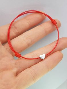 Cheap Red Jewelry With Adjustable Cord, Affordable Red Braided Bracelet With Adjustable Cord, Adjustable Red Heart Charm Bracelet, Valentine's Day Heart Bracelet With Sliding Knot, Adjustable Red Heart Friendship Bracelets, Adjustable Red Bracelets With Heart Charm, Adjustable Red Bracelet With Heart Charm, Adjustable Red Heart Bracelet For Friendship, Adjustable Red Heart Bracelet For Valentine's Day