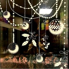 a window with ornaments hanging from it's sides