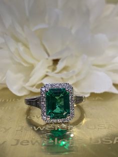 Emerald cut emerald engagement ring with diamond halo set in | Etsy 14k White Gold Emerald Ring With Brilliant Cut, Classic Princess Cut Emerald Ring With Halo Setting, 14k White Gold Emerald Cut Halo Ring, Emerald Cut Emerald Ring With Halo Setting, Classic Emerald Cut Ring With Diamond Accents, Classic Green Halo Ring With Diamond Accents, Formal Emerald Cut Emerald Ring With Halo, Emerald Cut Halo Ring For Promise, Classic Emerald Ring With Asscher Cut Halo