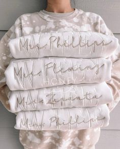 a person wearing a sweater with writing on it