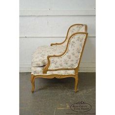 an antique chair with floral upholstered fabric