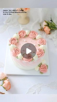 a cake with pink frosting and flowers on it