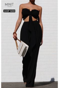 Elevate your summer wardrobe with this stunning black strapless top and high waisted loose pants set. Made from lightweight woven fabric, this set is perfect for hot weather. The smocked tube top features a stylish design with extra-long fabric pieces that can be tied into a bow, creating a fashionable bandeau look. Paired with the high-rise waist and wide-cut pant legs of the matching pants, this set exudes a sense of effortless sophistication and is a go-to choice for any occasion. Chic Cropped Two-piece Set Pants, Chic Cropped Two-piece Pants Set, Chic Cropped Pants Two-piece Set, Chic Cropped Two-piece Bottoms Set, Chic Cropped Pants For Evening, Cropped Summer Pants For Day Out, Elegant Tube Top For Day Out, High Waist Tube Top For Summer Day Out, Elegant Stretch Tube Top For Day Out