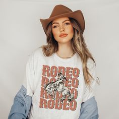 Rodeo Shirt | Rodeo Cowboy Shirt |  Saddle Up Buttercup Shirt | Cowboy T-Shirt | Cowgirl Shirt | Western Shirt| Country Girl Shirt Bella Canvas 3001  Available in Colors: White, Ash, Deep Heather, Heather Clay, Natural, Vintage Black, Dark Grey Heather This classic unisex jersey short sleeve tee fits like a well-loved favorite. Soft cotton and quality print make users fall in love with it over and over again. These t-shirts have-ribbed knit collars to bolster shaping. The shoulders have taping f White Letter Print Top For Rodeo, Trendy Short Sleeve Rodeo T-shirt, Trendy Short Sleeve T-shirt For Rodeo, Trendy Cotton T-shirt For Rodeo, White Graphic Tee For Rodeo, White Crew Neck T-shirt For Rodeo, White Short Sleeve T-shirt For Rodeo, Retro Letter Print Tops For Rodeo, Rodeo Short Sleeve Tops With Letter Print