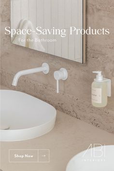 a white sink sitting under a bathroom mirror next to a soap dispenser