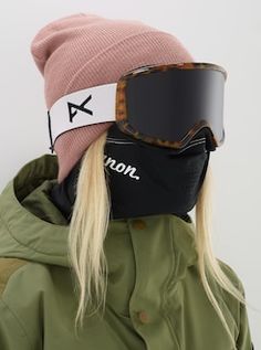 a woman wearing ski goggles and a beanie