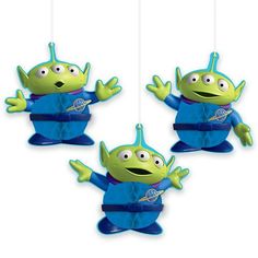 three green and blue toy figures hanging from strings