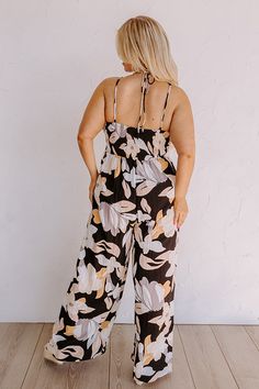 - Kick back and enjoy some vacay vibes in this stylish jumpsuit! - Unlined material with an abstract floral print - A v-cut neckline with a twist detail - Adjustable spaghetti straps - A smocked upper back with a tie detail - A wide legged jumpsuit with floor length hemlines Black Printed Jumpsuits And Rompers For Beach, Black Printed Jumpsuit For Beach, Black Floral Print Jumpsuits And Rompers For Vacation, Black Floral Print Jumpsuit For Vacation, Wide Legged Jumpsuit, Vacay Vibes, Stylish Jumpsuit, Black Curves, Abstract Floral Print