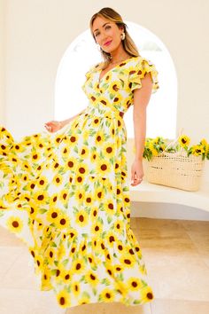 Introducing the Trixie Dress in Sunflower, your sunny daydream in full bloom! With its white, yellow, brown, and green sunflower print, it's a garden party delight. The V-shaped wrap neckline and short tiered flutter sleeves. Dance freely in the maxi-length tiered skirt with pockets for your essentials. Don't miss the hidden back zipper and ruffle detailing for that extra flair. Lined for comfort, this non-stretch sensation is ready to dazzle! Don't forget the matching mini & baby styles! Green Sunflower, Ivy City Co, Thanksgiving Dress, Sunflower Dress, Girls Holiday Dresses, City Woman, White Dress Party, Brown And Green, Holiday Party Dresses