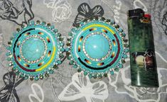 Turquoise beaded and center piece earrings with medicine wheel beaded circular line Turquoise Beaded Earrings, Beadwork Ideas, Turquoise Bead Earrings, Seed Bead Jewelry Patterns, Earrings Patterns, Medicine Wheel, Beaded Earrings Patterns, Beading Ideas, Earring Patterns