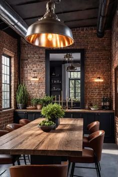 an industrial style kitchen with brick walls and wooden table surrounded by brown leather chairs, potted plants on the counter