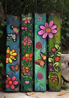 colorful painted wooden planks with flowers and butterflies on them