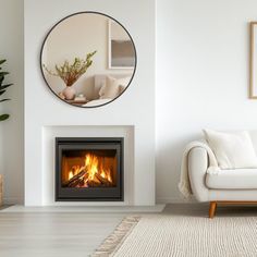 a living room with a white couch and a fire place in the middle of it