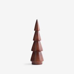 a small wooden christmas tree on a white background