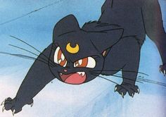 an animated image of a black cat with yellow eyes and big fangs on it's face