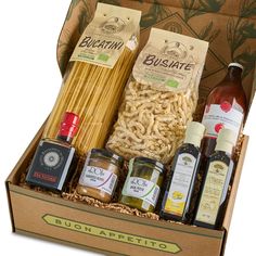 an open box containing pasta, sauces and condiments