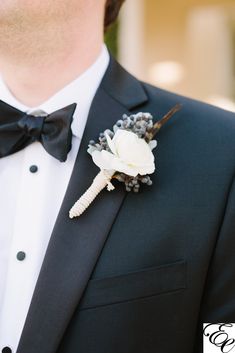 a man in a tuxedo wearing a boutonniere