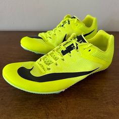 a pair of yellow and black nike shoes