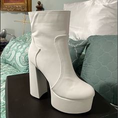 - These Ankle Boots Have Patent Vegan Leather Construction -Thick Platforms - Tall Chunky Heels N’ Side Zip Closures. - White - Man Made Materials - These Are In U.S. Sizing - 5.75" Heel - 2" Platform White Platform Heeled Boots For Party, White Synthetic Heeled Boots For Party, White Faux Leather Platform Boots For Party, White Closed Toe Platform Boots For Party, Chic White Faux Leather Platform Boots, White Faux Leather Heeled Boots For Party, White Almond Toe Heels In Faux Leather, White Platform Boots With High Stacked Heel, White Synthetic Boots With Padded Heel