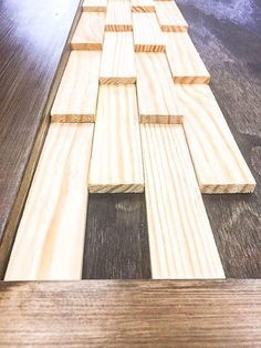 wooden planks laid out on the floor to be used as a wall art piece