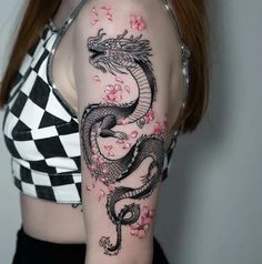 a woman with a dragon tattoo on her arm