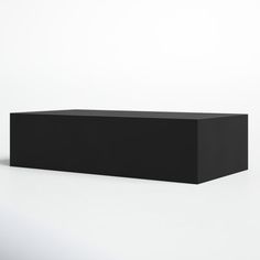 a black box sitting on top of a white table