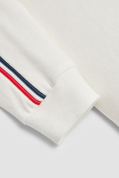 Easy to wear alone or layer under heavier items, this polo shirt is crafted from cotton piquet. Adding a finishing touch of brand DNA, a tricolor stripe completes the long-sleeved style. White Collared Top With Signature Stripes, White Collared Polo Shirt With Signature Stripes, White Collared Polo Sweater With Ribbed Cuffs, White Collared Top With Ribbed Cuffs, White Collared Polo Sweater With Ribbed Collar, White Collared Tops With Ribbed Cuffs, White Long Sleeve Polo Sweater With Striped Collar, Striped Cotton Polo Sweater, White Polo Shirt With Striped Cuffs