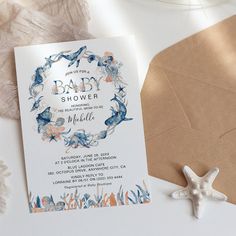 a baby shower is shown next to a starfish and seashell on the table