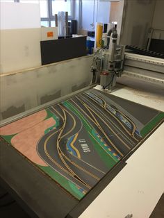 an image of a machine that is cutting out some pictures on the paper with it