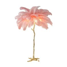 a pink feather lamp on a white background