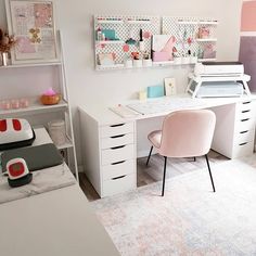 a white desk and chair in a room with lots of shelves on the wall behind it