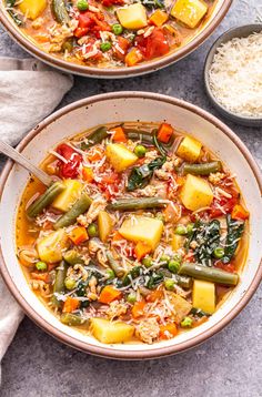 two bowls filled with vegetable soup and rice