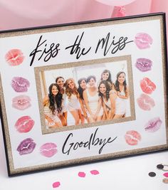 a photo frame with lipstick kisses and the words kiss the miss goodbye