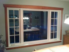 a dining room window reflecting the kitchen and living room