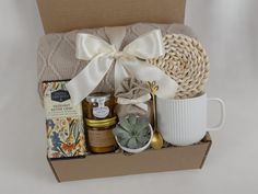 a gift box with coffee, honey and succulents is shown in front of a white background