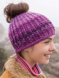 a woman wearing a purple hat and smiling