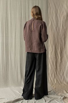 "High neck linen blouse. This blouse is tailored clean and minimalistic with deep neck detail with snap closure at the back. Slightly puffed long sleeves finishes with narrow elasticated cuffs. You will feel great wearing it at work or special events. Tuck it into high-rise trousers to create a pleasing silhouette. Double washed for extra softness and for shrinkage prevention. ABOUT US LINEN ID was born from desire to embrace things that actually matter. We aim to create sustainable garments tha Spring Linen Top With Stand Collar, Spring Linen Stand Collar Tops, Relaxed Fit Blouse With Stand Collar For Fall, Linen Blouse With Lantern Sleeves, Chic Linen Blouse With Balloon Sleeves, Spring Linen Puff Sleeve Top, 3/4 Sleeve Linen Blouse For Work, Linen Tops With Gathered Puff Sleeves, Collared Linen Tops With Roll-up Sleeves