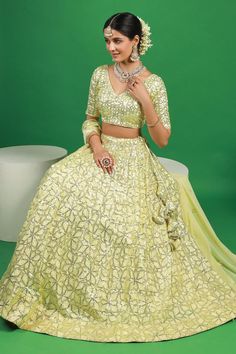 Lemon yellow lehenga with attached can can and sequin embroidered floral motifs. Comes with padded blouse and dupatta.
Components: 3
Pattern: Embroidered
Type Of Work: Thread, Sequin
Neckline: V-neck
Sleeve Type: Half
Fabric: Georgette
Color: Yellow
Other Details: 
Attached lining
Lehenga Length: 42 inches
Model Height: 5ft 4inches wearing size S
Closure: 
Lehenga: Side drawstring
Blouse: Back hook
Occasion: Mehendi and Haldi,Sangeet - Aza Fashions Lemon Yellow Lehenga, Sequin Lehenga, Yellow Lehenga, Blouse Back, Padded Blouse, Can Can, Lemon Yellow, Floral Motifs, Set For Women