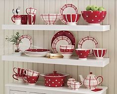 red and white dishes on shelves in a kitchen