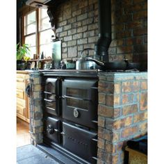 an old fashioned stove in the middle of a kitchen