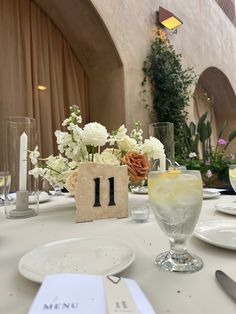 the table is set with flowers and place settings