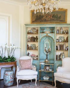 a living room filled with furniture and a chandelier