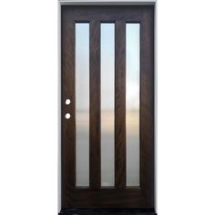 the front door is made from wood and has frosted glass panels on each side