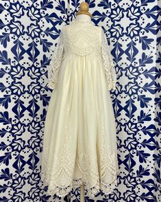 A unique and exquisite full vintage lace gown. Beautiful hand-embroidered lace in ivory. It has three clip-on on the back for closure. Does not include bonnet Made in Spain 100% polyester Dry Cleaning Final Sale, no exchanges nor returns are available Victorian Dress With Lace Bodice, Cream Lace Gown For First Communion, Cream Wedding Gown With Lace Trim, Formal Embroidered Lace Dress, Cream Lace Dress With Scalloped Lace For First Communion, Cream Fitted Baptism Dress With Lace Sleeves, Cream Lace Dress For First Communion, Cream Scalloped Lace Dress For First Communion, Cream Lace Long Sleeve Gown