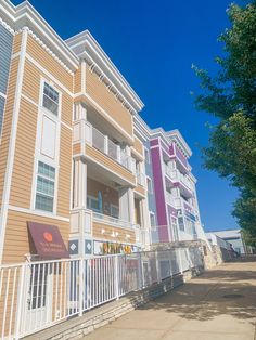 two multi - story apartment buildings with balconies on the second and third floors