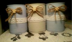 three blue and white buckets with bows on them sitting on top of a table