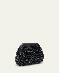 Cult Gaia "Nia" clutch bag in beaded acrylic and leather     Structured top with hinge closure     Lining: Polyester/polyurethane    Approx. 6.5"H x 12.5"W x 3"D    Imported Leather Top Handle Clutch For Party, Handheld Leather Clutch For Parties, Beaded Top Handle Evening Bag, Evening Handheld Beaded Clutch, Rectangular Leather Evening Coin Purse, Rectangular Leather Coin Purse For Evening, Black Beaded Pouch Clutch, Evening Leather Pouch Coin Purse, Leather Evening Coin Purse Pouch